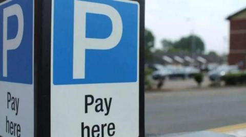 A large white letter P on blue background about the words Pay Here 