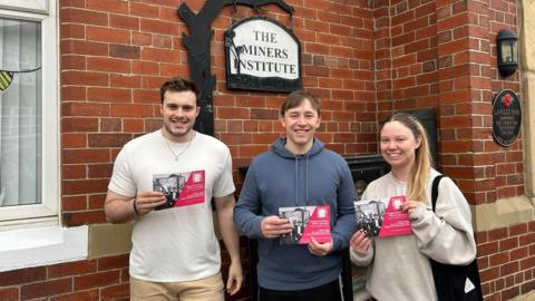 Jack Pringle, centre, in a blue hoodie and his fellow campaigners Amy McClure (right) and Alex Lowerson Parker (left). Amy is wearing a white jumper and Alex is wearing a white T-shirt.  