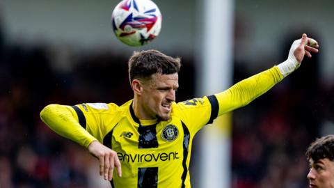New Crewe Alexandra striker Josh March heads the ball while playing for Harrogate Town