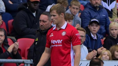 Rob Atkinson walking down the touchline after being substituted for Bristol City