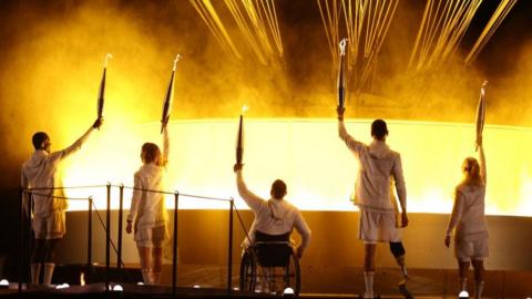 France's paralympic torchbearers, Charles-Antoine Kaoukou, Nantenin Keita, Fabien Lamirault, Alexis Hanquinquant and Elodie Lorandi hold the Paralympic flame