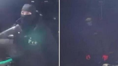 Police photos of two men dressed all in black with their faces covered. One has on red gloves.