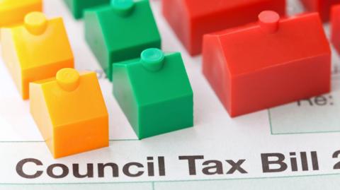 A generic image of a council tax bill with some monopoly houses and hotels on it