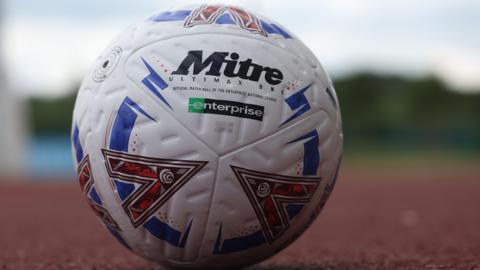 A National League football on an athletics track