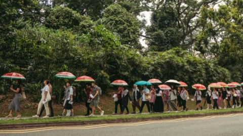 Participants of the event carried umbrellas with watermelon graphics