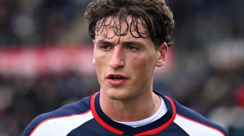 Close up shot of Barney Stewart in a red, white and blue training top