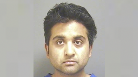 A mugshot of Salil Korambayil looking toward the camera. He has dark hair and eyes.