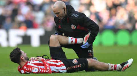 Sunderland's Patrick Roberts is treated for an injury against Cardiff City