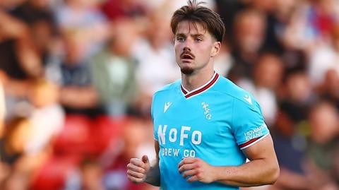 Jamie Jellis is his light blue Walsall away shirt during a match