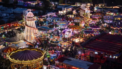 Overhead aerial view of the Goose Fair with a helter skelter and merry-go-round prominent along with other fairground rides