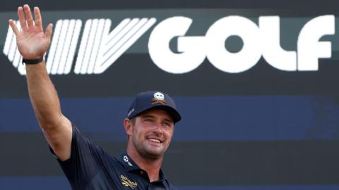 Bryson DeChambeau waves to fans in front of a LIV Golf logo during day four of LIV Golf New York at Trump National Golf Club in August 2026