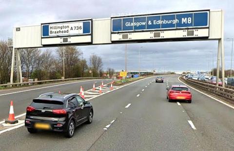 A Google view of the M8 motorway at Junction 26 shows the affected slip road. The gantry above the road bears the number 26 ans signposting for Hillington, Braehead, Glasgow and Edinburgh.