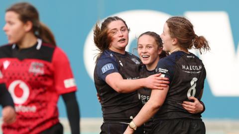  Hannah Smyth is congratulated by team mates after scoring a try