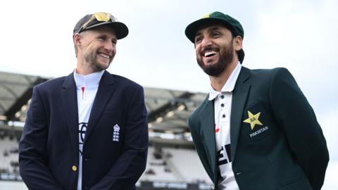 England captain Joe Root alongside Pakistan captain Salman Agha before the first Test. Both men are wearing caps and blazers and smiling
