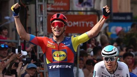 Jonathan Milan celebrates winning stage two of the 2025 Criterium du Dauphine