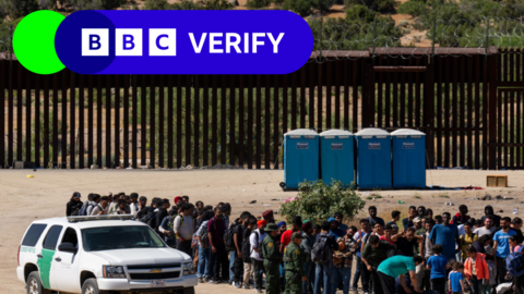 鶹Լ Verify logo over an image of migrants at the US southern border.