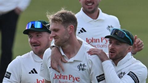 Dillon Pennington of Notts gets congratulated by two team-mates