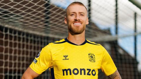 A smiling Dan Bentley wearing Coventry's goalkeeper kit