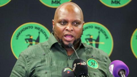 Floyd Shivambu from South Africa's MK Party is seen addressing the media in a green shirt bearing his party's logo