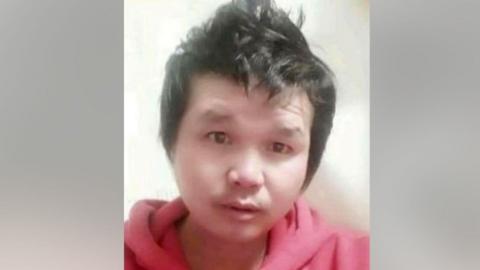 Photograph of Suthisak Rintalak. His hair is styled pointing up and he is wearing a red hoodie