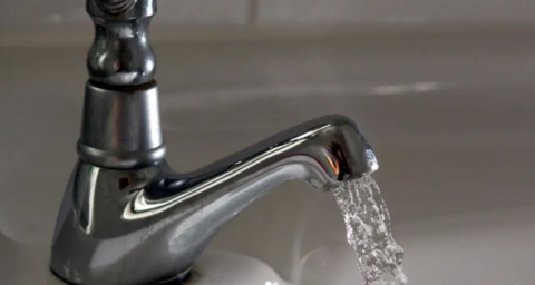 A stock image of a tap with water coming out.