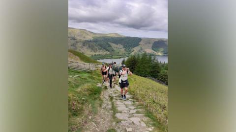 The teams carrying their equipment up the mountain