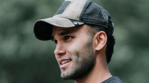 Ibi Akhtar in a baseball cap