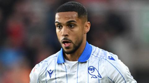 Max Lowe, wearing Sheffield Wednesday's white away shirt with a blue collar and blue pinstripes with the Owls badge on the front, during a game against Middlesbrough