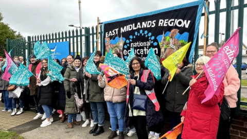 Sir Francis Hill Community Primary School staff on a picket line holding placards