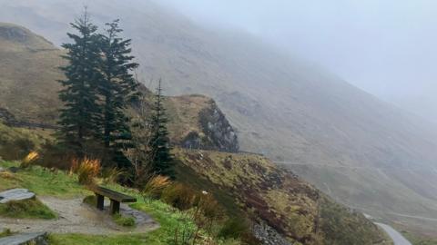 A mountain road on a wet and windy day