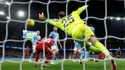 Donnarumma dives as Andy Robertson ducks