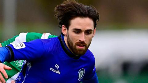 Aidan Barlow, wearing Rochdale's blue home shirt with a black collar, pictured during a game against Yeovil Town in February 2026