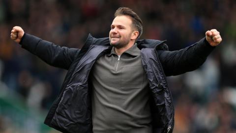 Plymouthg Argyle boss Tom Cleverley, with his arms outstretched, celebrates his side's win over Luton Town