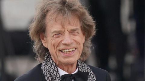 Mick Jagger wearing black tie for a formal event.