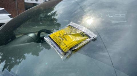 Parking tickets stuck onto a car window