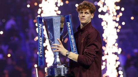 Jannik Sinner poses with the ATP Finals trophy