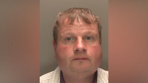 Police mugshot of Marc Gothorp. He has fair hair and is wearing a light-coloured shirt. He is looking directly at the camera.