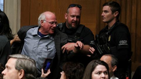 Image shows Ben Cohen, co-founder of ice cream company Ben & Jerry’s, being removed by US Capitol Police at a Senate Health, Education, Labor & Pensions Committee hearing in Washington, DC, on 14 May, 2025
