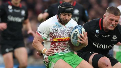 Leigh Halfpenny holds on to the ball under pressure from an opponent