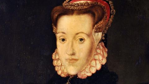 A 16th Century painting of a young woman with pale skin, chestnut hair and a sad, serious expression on her face. She is wearing a black dress with white and pink ruffled collar, and a French hood-style cap, which appears to be made of white cloth and red velvet, with decorative metallic bands.