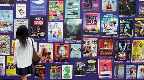 A wall covered in posters for shows at the Edinburgh Fringe festival