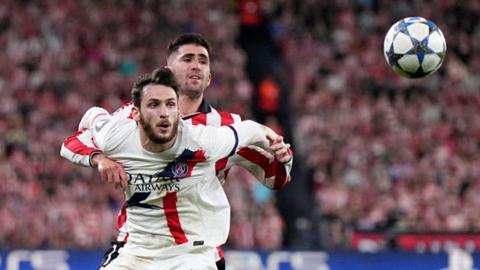 Khvicha Kvaratskhelia fights for the ball with Jesus Areso Blanco