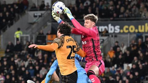 Coventry goalkeeper Carl Rushworth claims a cross while under pressure