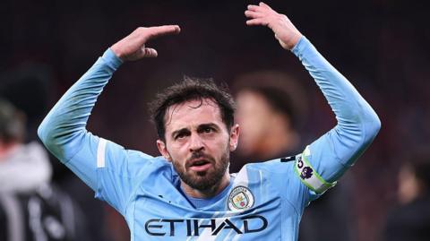 Bernardo Silva lifts arms to encourage fans