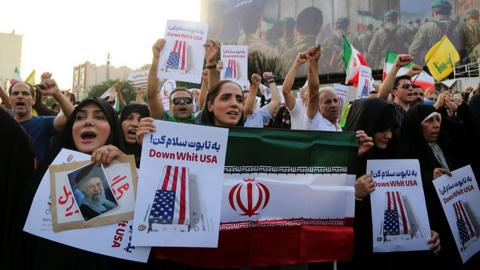 Crowds holding Iranian flags gather in the Revolution Square in the capital Tehran to protest the US attacks on three nuclear facilities in Iran on June 22, 2025.