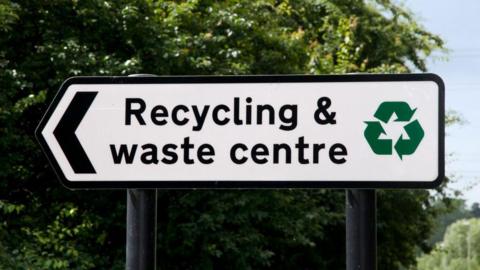 Sign that reads 'recycling and waste centre'