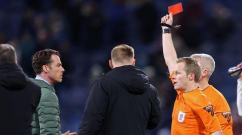 Referee Gavin Ward (right) shows Burnley manager Scott Parker (left) a red card after the final whistle