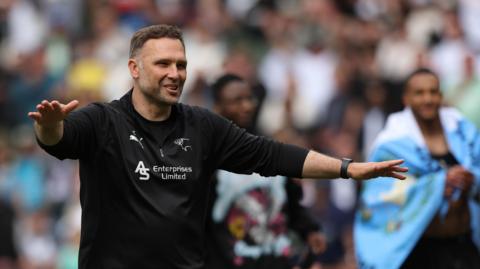 Derby County boss John Eustace celebrates the draw with Stoke that keeps the Rams in the Championship