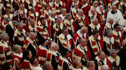Members of the House of Lords listen to the King's Speech during the State Opening of Parliament in chamber of the House of Lords at the Palace of Westminster, London in 2024.