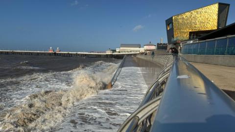 Waves crashing in the sea at Blackpool during gusts as Storm Ashley hits. Blackpool North Pier and the wedding chapel can be seen in the background.